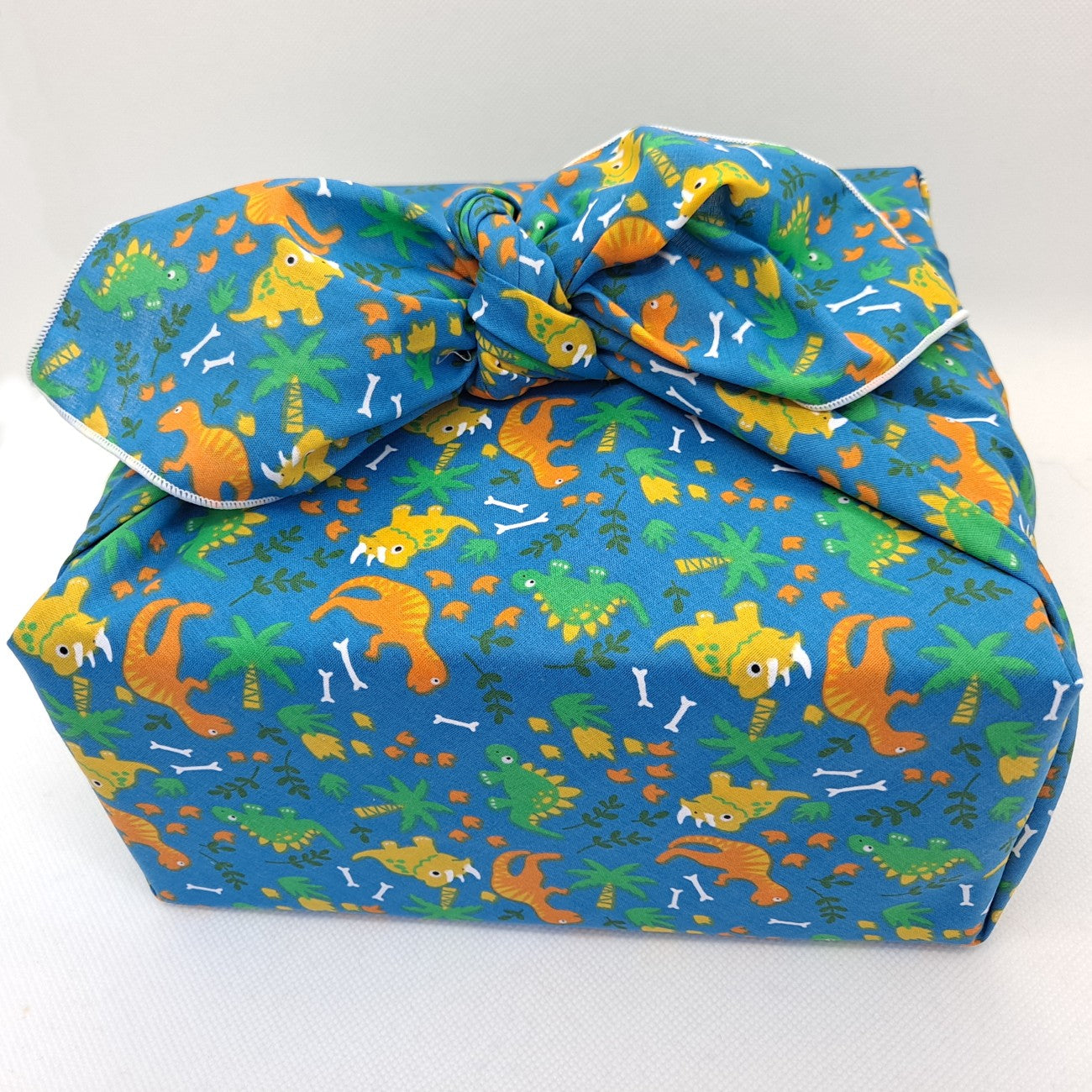 Gift wrapped in roaming dinosaurs furoshiki
