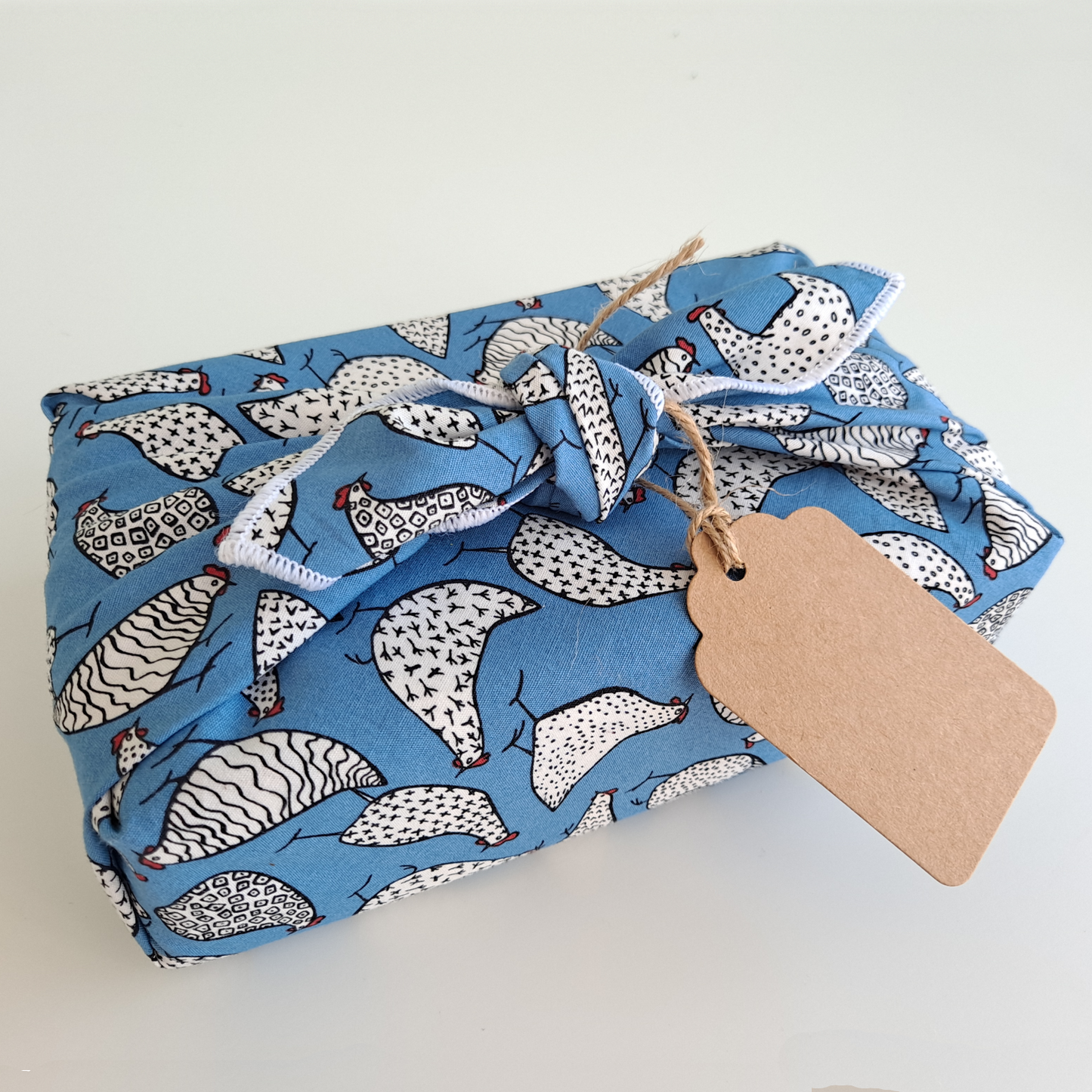 Furoshiki wrapped gift and recycled kraft gift tag with jute string