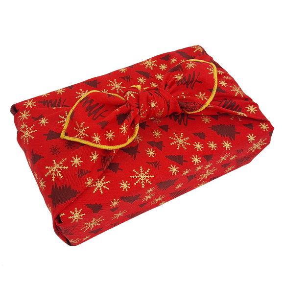 Gift wrapped in a red Christmas print furoshiki with Christmas tree and snowflake detail