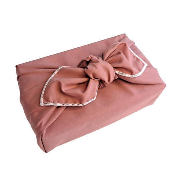 Dusky pink furoshiki with white trim, reusable fabric gift wrap
