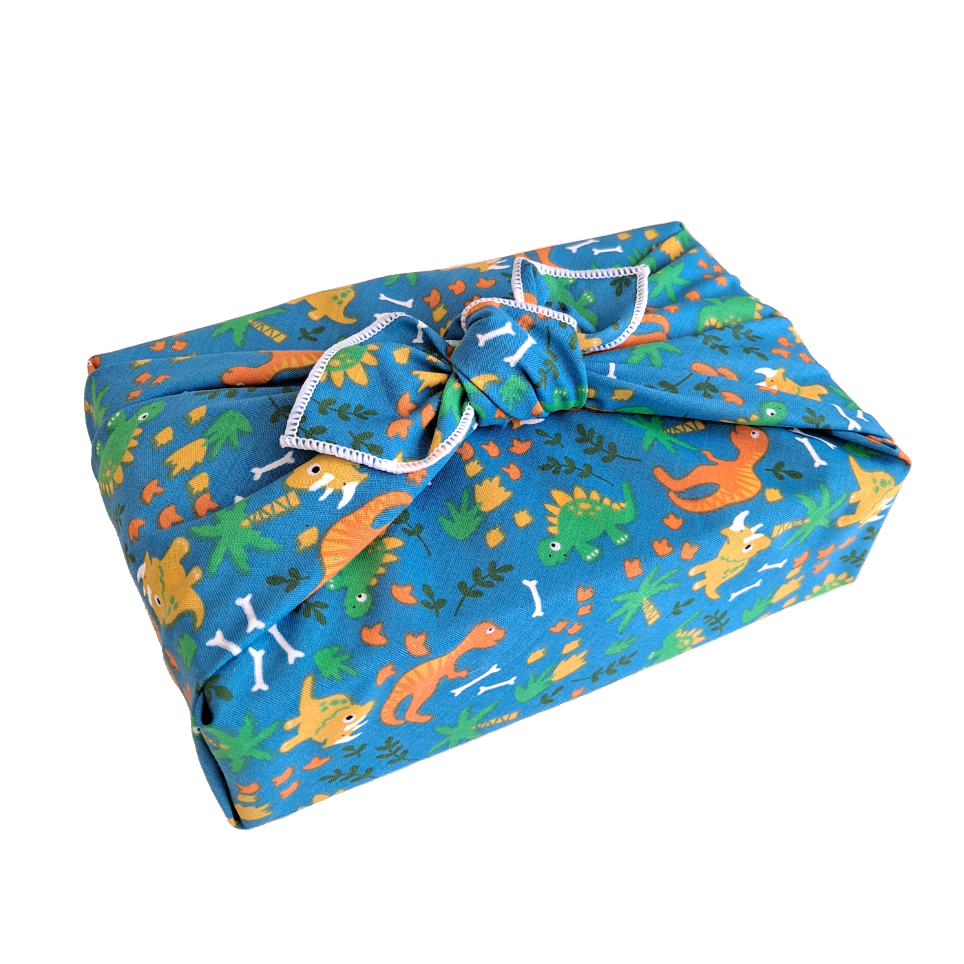 Gift wrapped in a reusable furoshiki wrapping cloth with a roaming dinosaur print