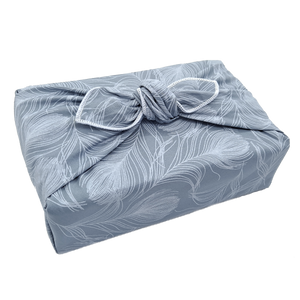 Gift wrapped in a furoshiki with a delicate feather pattern on silvery grey