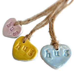 Ceramic heart shaped gift tags imprinted with the word hug