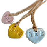 Ceramic heart shaped gift tags imprinted with the word hug