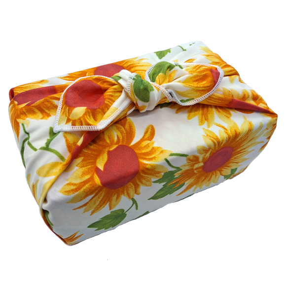 Gift wrapped with a sunflower patterned furoshiki reusable gift wrap