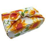 Gift wrapped with a sunflower patterned furoshiki reusable gift wrap