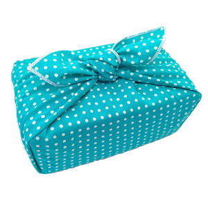 Gift wrapped in a furoshiki that's turquoise with white spots