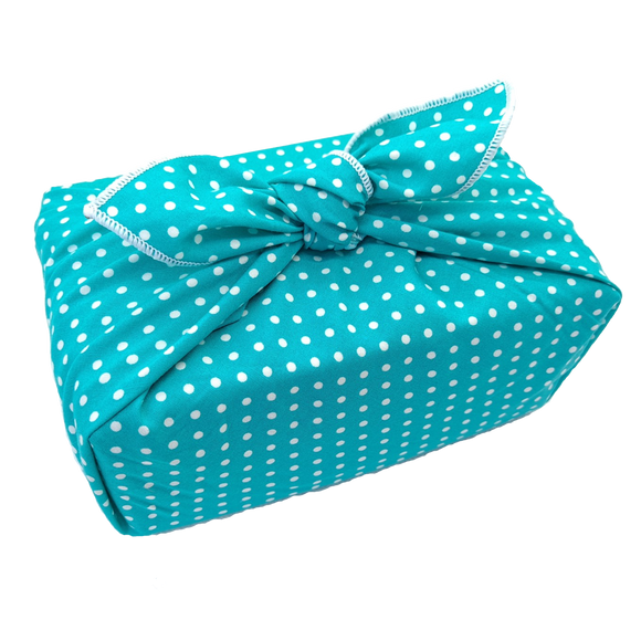 Gift wrapped in a furoshiki that's turquoise with white spots